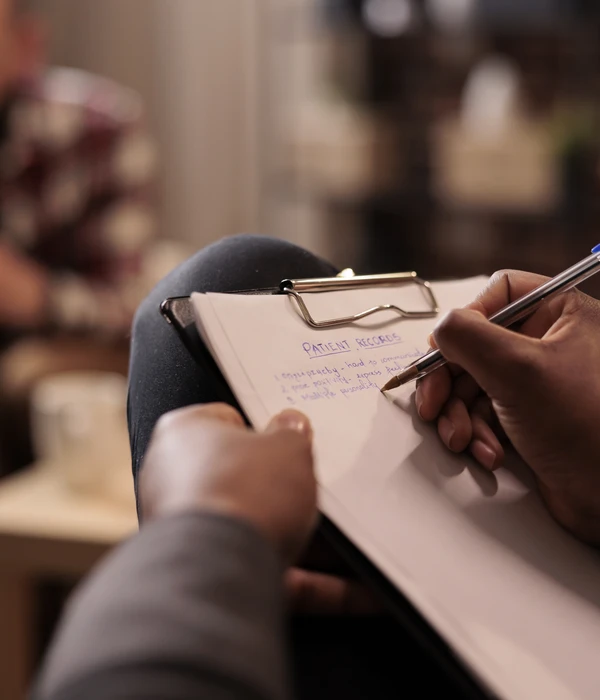 male-psychologist-taking-notes-couple-therapy-session-help-page