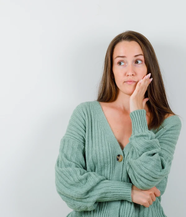 young-girl-leaning-cheek-palm-looking-away-knitwear-page